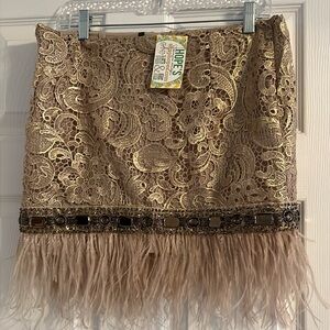 Beige skirt with brown rhinestone and feather bottom